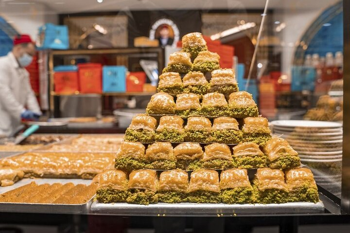 Immerse yourself in Dubai's culinary scene exploring local markets and savoring irresistible treats like baklava crafted with love and rich flavors that tell a story.